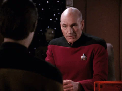TV gif. Sir Patrick Stewart as Picard from Star Trek Next Generation sits in a seat across from Data. He looks at him a bit shocked and then crumbles down into his hands to facepalm in agony.